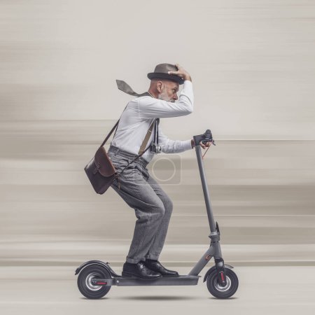 Photo for Vintage style traveler holding a suitcase and riding an electric scooter - Royalty Free Image