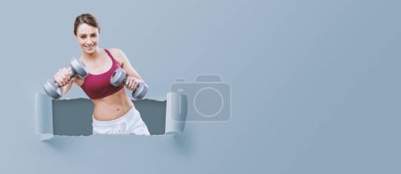 Photo for Smiling young sportswoman working out with dumbbells, sports and training concept - Royalty Free Image