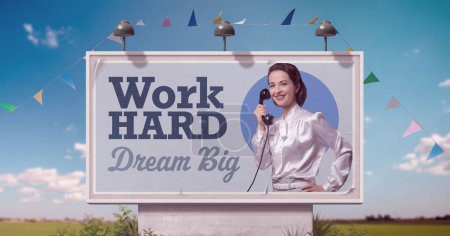 Photo for Confident vintage style businesswoman and motivational quote on billboard advertisement: work hard, dream big - Royalty Free Image