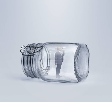 Corporate businessman trapped inside a glass jar, he is using a megaphone and shouting