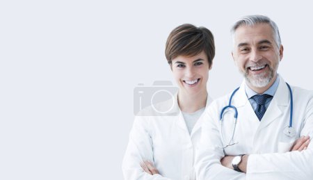 Foto de Equipo médico profesional posando juntos y sonriendo, concepto de atención médica y asistencia médica, espacio para copiar - Imagen libre de derechos