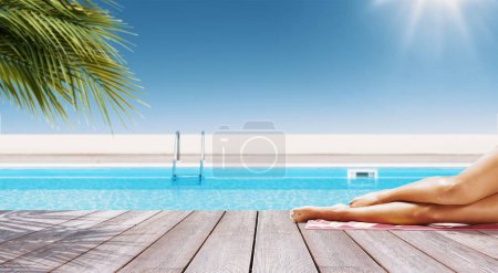 Photo for Young beautiful woman sunbathing at the tropical resort, swimming pool in the background, summer vacations concept - Royalty Free Image