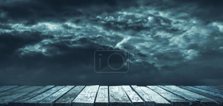 Photo for Old ruined wooden pier and dark cloudy sky, horror and darkness background - Royalty Free Image