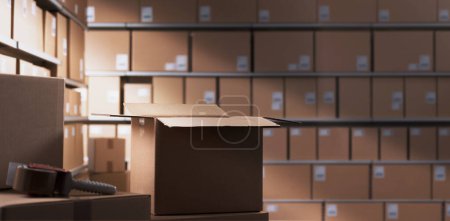 Photo for Distribution warehouse interior with many cardboard boxes on shelves - Royalty Free Image