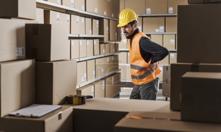 Photo for Tired warehouse worker having a bad back pain at work - Royalty Free Image