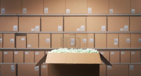 Open delivery box filled with packing chips, warehouse shelves with boxes in the background