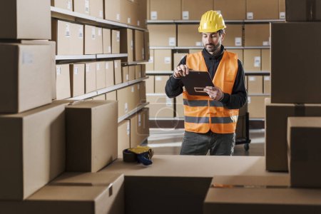 Photo for Warehouse worker holding a clipboard and checking boxes, logistics and shipment concept - Royalty Free Image