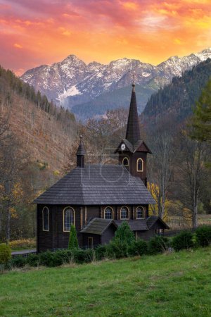 Hermosa puesta de sol de otoño sobre la Iglesia de Santa Ana en las montañas eslovacas de Tatras