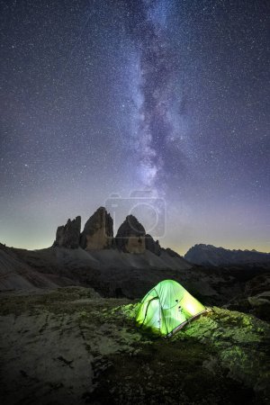 Photo for Night sky over mountains and green tent - Royalty Free Image
