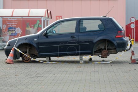 Photo for Poland, Poznan - October 30, 2022: Theft, car stolen without wheels parked in market parking lot. - Royalty Free Image