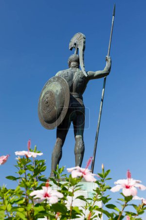 Photo for Statue of Achilles carrying a spear and shield in the garden of Achilleion on the Ionian island of Corfu, Greece. Shot from behind. - Royalty Free Image