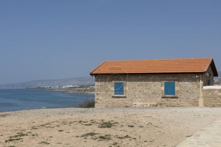 Photo for Seaside Stone Cottage Under Clear Blue Sky, - Royalty Free Image