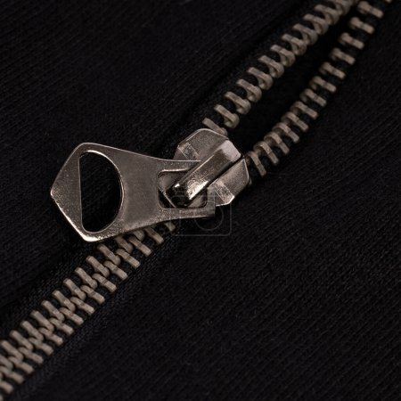Close-Up of Silver Zipper on Black Fabric