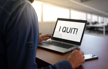 Téléchargez les photos : Worker in an office with the message I quit on screen. Business Quiet quitting concept or burnout - en image libre de droit
