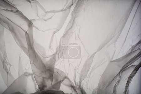 Foto de Abstract Texture Crumpled Polyethylene White Grey Background,Pattern Crease Plastic Bag with Sun Shine Backdrop,Film Wrap Grunge,Overlay Poster Tape Card Foil Paper Sticker Mockup Pack Wrapper - Imagen libre de derechos