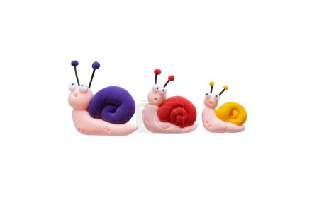 Plasticine three colored snails on a white background