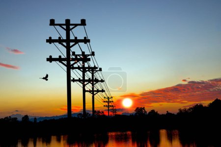 A breathtaking view of high voltage poles silhouetted against a vibrant sunset, perfect for energy and nature-themed projects. 3D Illustration