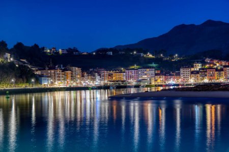 Entrance to the port of Ribadesella, with Santa Marina beach, on a starry night. Asturias, Spain.