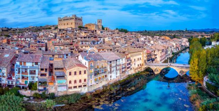 Photo for Aerial view of the town of Valderrobres with its bridge and its castle at sunset in Teruel, Spain. - Royalty Free Image