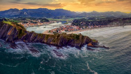 Aerial view of Ribadesella and its estuary at sunset in Asturias, Spain.