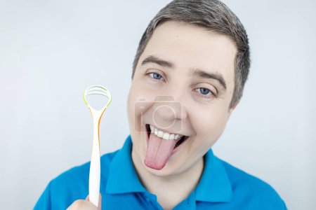 Tongue scraper. Man shows yellow plaque and then performs oral hygiene. Cleaning the tongue with special tool. Doctor recommendations and dentist advice. Before and after. Removing unpleasant odor