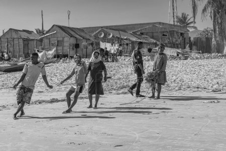 Foto de Morondava, Madagascar - May 31.2023: People pull a rope to fish at the coastline from Morondava, black white - Imagen libre de derechos