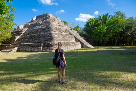 Photo for Chacchoben Mayan ruins in Costa Maya Mexicon and back view of tourist woman - Royalty Free Image