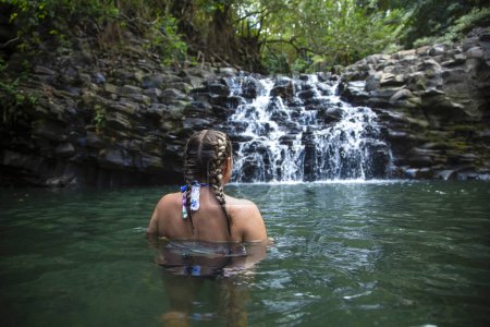 Photo for Back view of caucasian woman looking at waterfall - Royalty Free Image