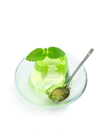Green  jelly on glass saucer isolated on white 