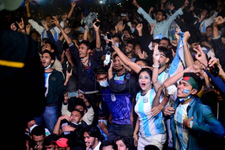 Photo for Bangladeshi Argentinian supporters react as they watch the final football match of the Qatar 2022 World Cup between Argentina and France at the Dhaka University Campus in Dhaka, Bangladesh on December 18, 2022. - Royalty Free Image