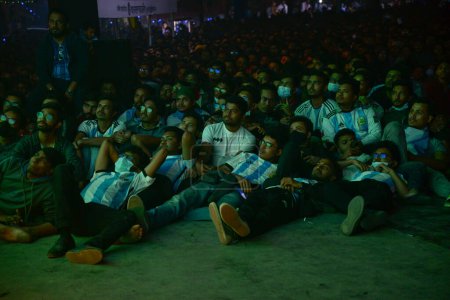 Photo for Bangladeshi soccer fans watch on a big screen a public broadcast of the FIFA World Cup Qatar 2022 match between Argentina and France final Match at the Dhaka University Campus, in Dhaka, Bangladesh, on December18, 2022. - Royalty Free Image