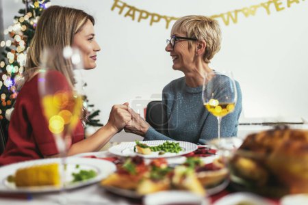 Photo for Mother and daughter having great time at Christmas dinner - Royalty Free Image