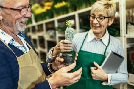 Photo for Elderly couple in own flower shop. Concept of small business. - Royalty Free Image