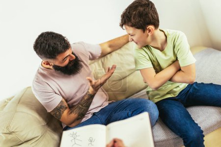 Photo for Internet addicted boy visiting therapist with his father - Royalty Free Image