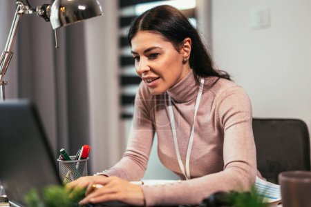 Foto de Una mujer joven está teniendo una reunión de vídeo en línea o entrevista de trabajo en un ordenador portátil en casa. - Imagen libre de derechos