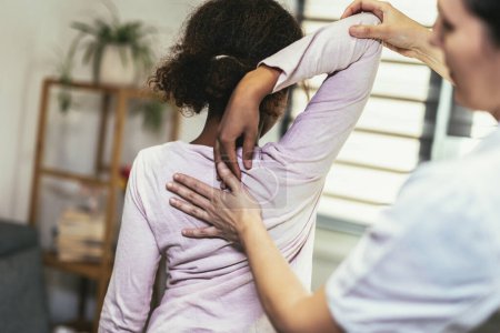 Photo for Teen Girl having chiropractic back adjustment. Osteopathy, Physiotherapy, Kinesiology. Bad posture correction - Royalty Free Image