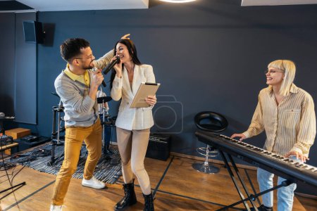 Photo for Business people making team training exercise during team building seminar singing karaoke. - Royalty Free Image