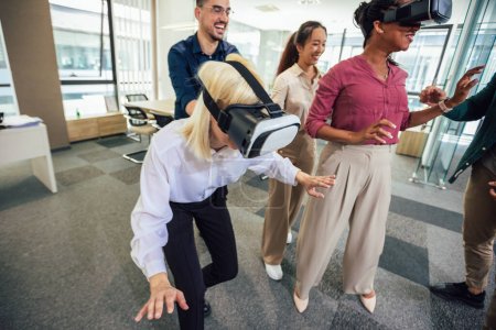 Photo for Group of professional people playing with VR glasses on the work in the modern office.Team Building - Royalty Free Image