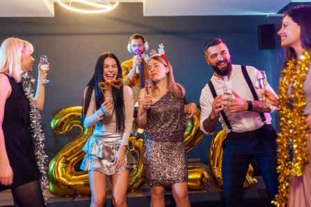 Photo for Group of people dancing in the club celebrating New Years - Royalty Free Image