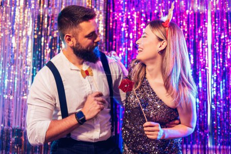 Photo for Portrait of happy young couple posing together at nightclub - Royalty Free Image