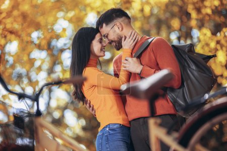 Photo for Young couple being in love. Sunny autumn day in colorful park - Royalty Free Image