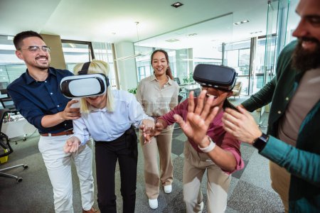 Photo for Group of professional people playing with VR glasses on the work in the modern office.Team Building - Royalty Free Image