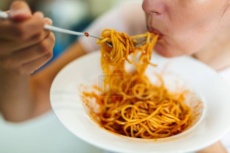 Photo for Close-up of woman eating spaghetti bolognese - Royalty Free Image