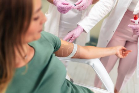 Photo for Nurse takes blood from the patient's hand - Royalty Free Image