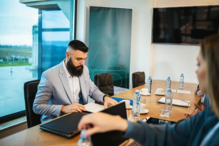Photo for Group of businesspeople having a briefing in a boardroom. Businesspeople working together in a modern workplace. - Royalty Free Image