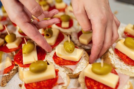 Photo for Close up of woman's hand preparing canape. - Royalty Free Image