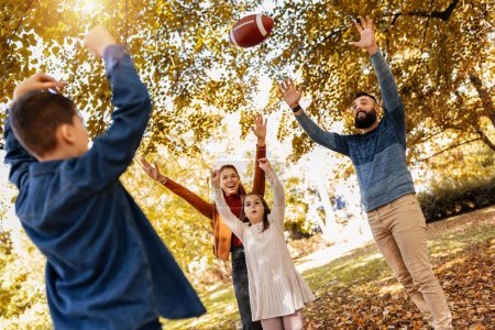 Photo for Family playing american football in park. Family and kids, nature concept. - Royalty Free Image