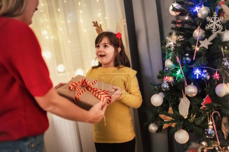 Photo for Daughter receives gifts from her loving mother on Christmas. - Royalty Free Image