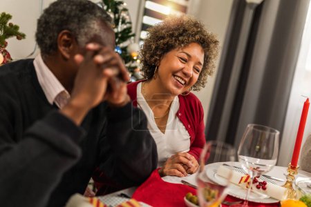 Photo for Grandparents talking on Christmas dinner. - Royalty Free Image