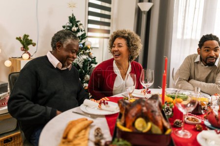 Photo for Grandparents smilling. Christmas Eve dinner. - Royalty Free Image